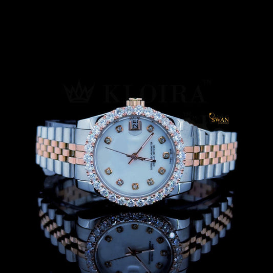 Two-tone watch with a white dial, a diamond-encrusted bezel, and a silver and rose gold link band with a date display by swandiamond