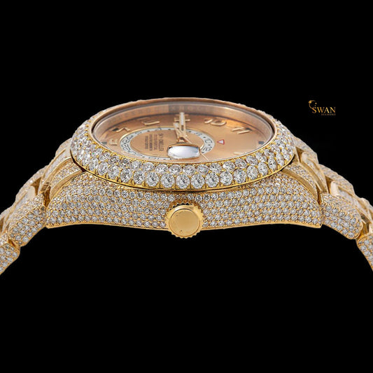 Full gold iced-out Sky-Dweller watch with a pave and baguette diamond bezel, and a date display on a link band by swandiamond