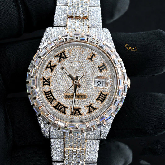 Iced-out two-tone watch with a pave diamond dial, a baguette and pave diamond bezel, and a link band by swandiamond