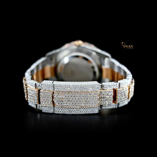 Iced-out two-tone watch with a pave diamond dial, a baguette and pave diamond bezel, and a link band by swandiamond
