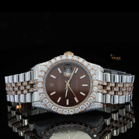 Rose gold and silver-toned iced-out watch with a brown dial a diamond encrusted bezel and a link band by swandiamond